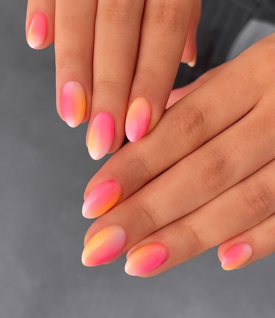 A pair of hands showing off stylish, short aura nails