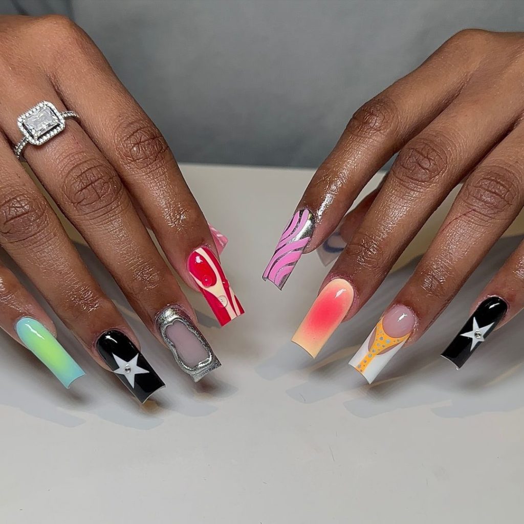 A pair of hands showing off stylish, long aura nails