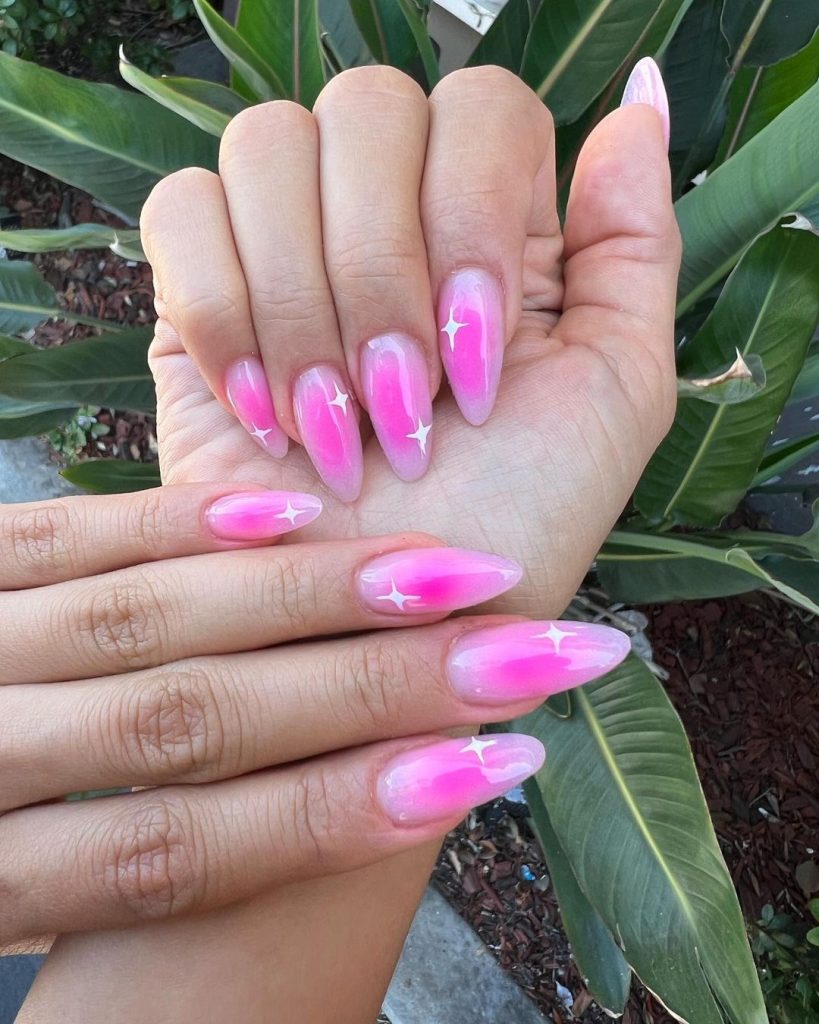 A pair of hands showing off stylish, short aura nails