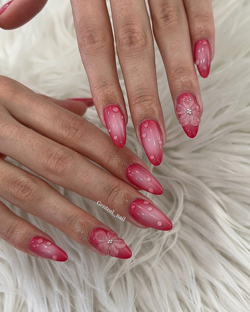 A pair of hands showing off red, short aura nails