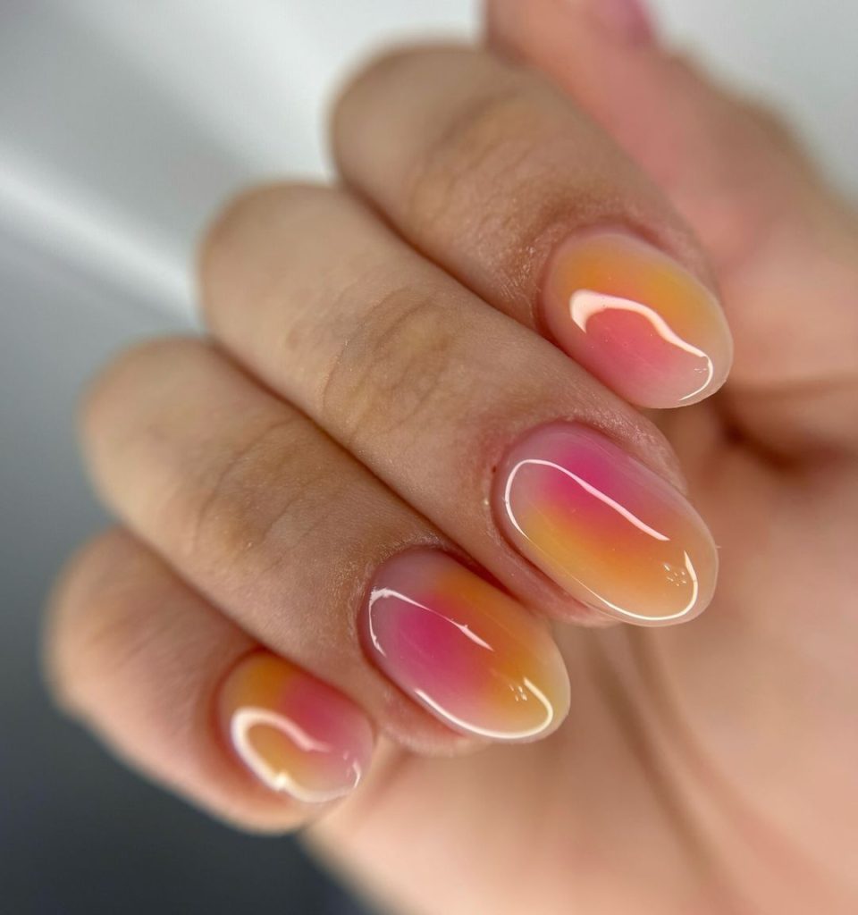A pair of hands showing off stylish, almond-shaped aura nails