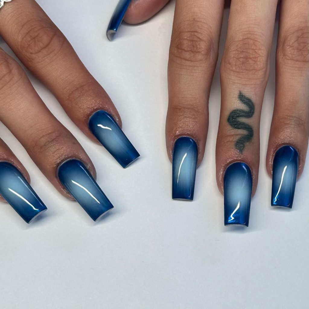 A pair of hands showing off stylish, coffin-shaped aura nails